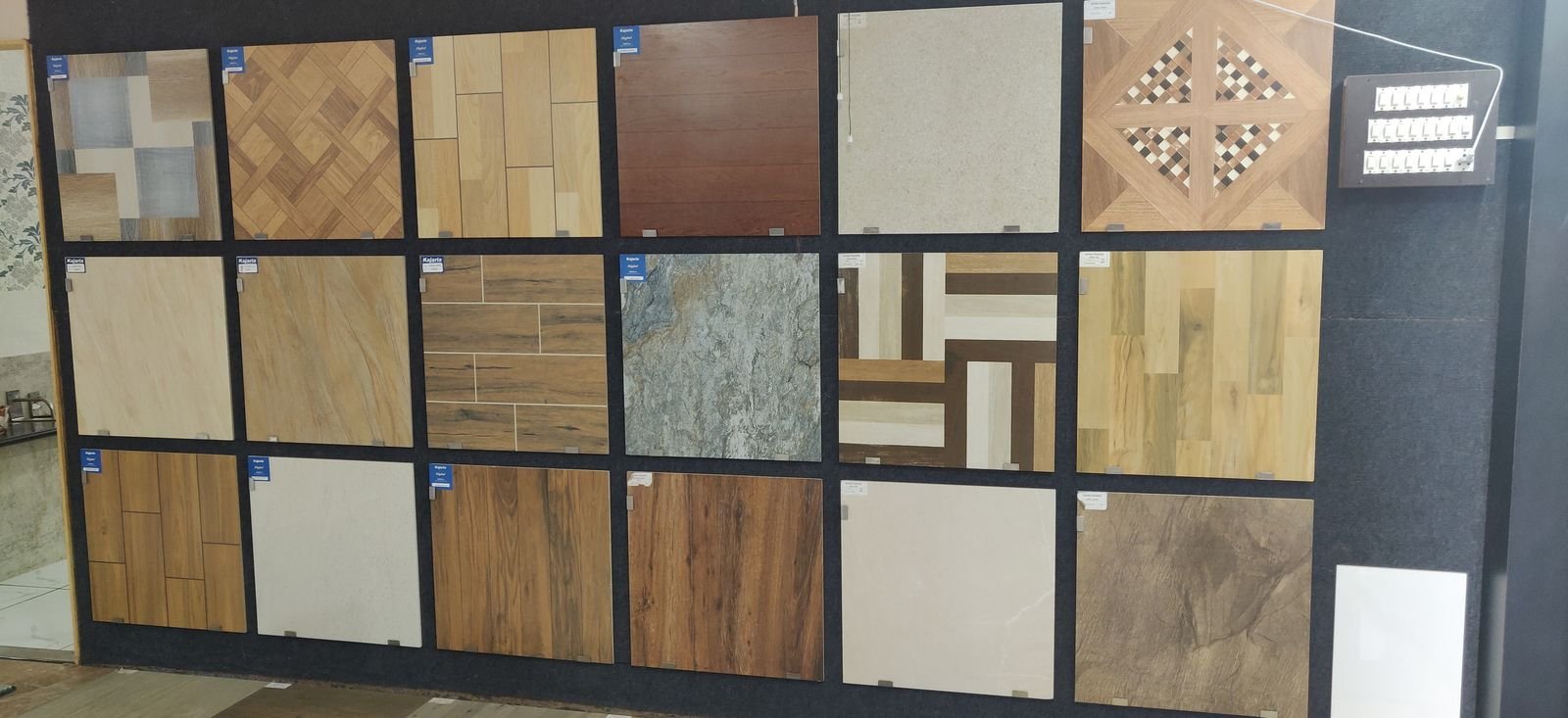 Wooden finish and designer tile samples on a display wall